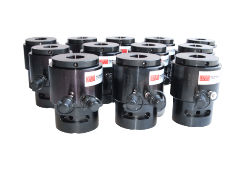Tensioners with dual hydraulic couplings